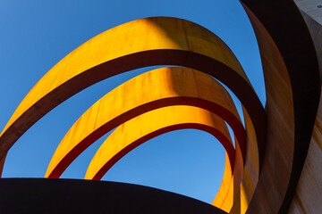 Abstract view of a modern sculptural architecture with vibrant red and yellow curves.