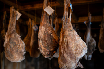 Aging hams hanging in a traditional curing room