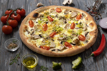 Italian pizza with ingredients.Pizza with cherry tomatoes,mashrooms,sousage and salad.