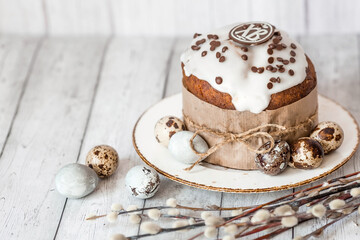 Stylish grey Easter eggs in the colors of marble, concrete, willow branches, Easter bunnies and Easter cake on a white wooden background. Coloring eggs for Easter.  The feast of bright Easter.