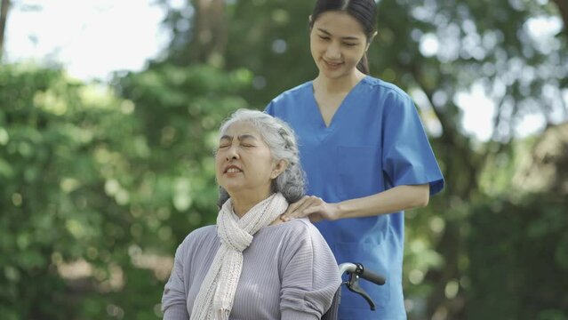 Professional physiotherapist taking care of asian senior patient during rehabilitation.