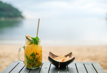 Passion fruit cocktail with snacks on the table