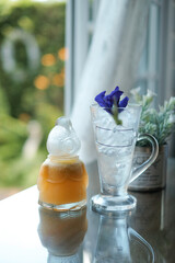 orange juice in chicken bottle and ice in a glass