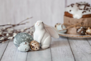 Stylish grey Easter eggs in the colors of marble, concrete, willow branches and Easter chicken on a...