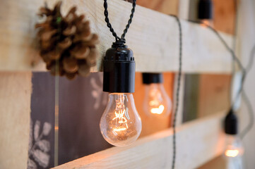 Hanging bulbs with warm light as decor in the living room - 706325480