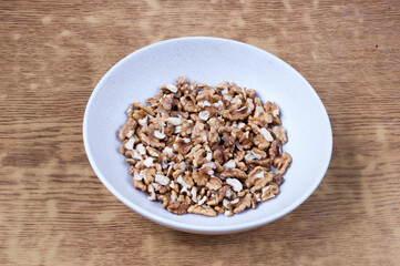 Nutty Delights: Top View of a Pile of Walnuts on a White Plate