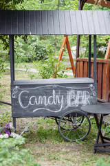 Decorative black wooden cart in the garden as a candy bar - 706327805