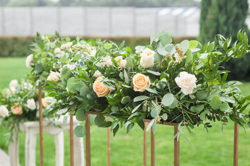 Floral Composition: Close-Up of Wedding Centerpiece. Elegant Arrangement featuring Various Roses and Greenery, Adding Beauty to the Wedding Decoration - 706329270