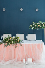 Elegant wedding table covered with pink tablecloth and white tulle. Vertical photo orientation - 706329281