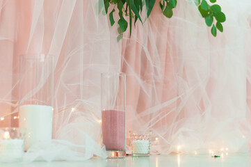 Wedding table decorated with pink tablecloth and white tulle.