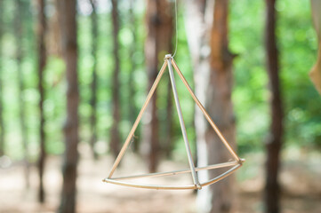 Aesthetic Tetrahedral Metal Decor Element Amidst a Forest Setting. - 706331298