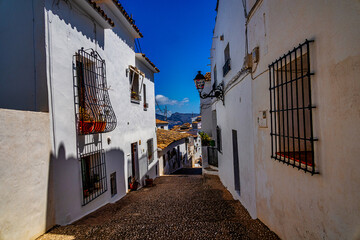 urban narrow street in the Spanish city of Altea on a summer day
