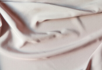 Light milky fabric, satin abstract background. Beautiful soft wavy folds on smooth luxury shiny...