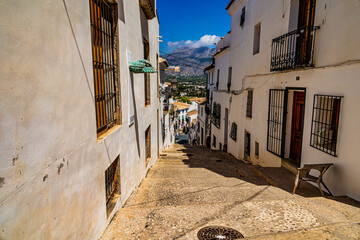 urban narrow street in the Spanish city of Altea on a summer day