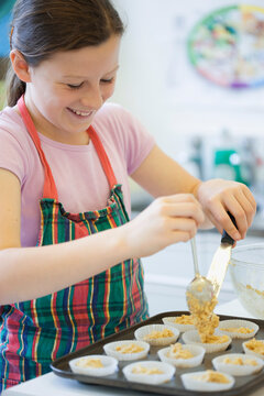 Young girl in cookery class baking
