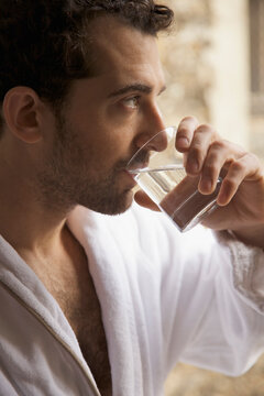 Close up profile of a man drinking water
