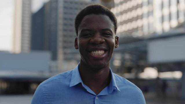 Portrait of the Smiling Successful Young African American Entrepreneur Standing Outside and looking at the Camera. Smiling Multi Ethnic Guy Posing to the Camera on the City Background