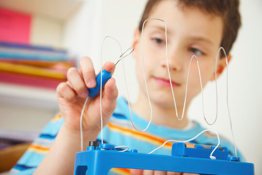 Boy Playing with Wire Coordination Game
