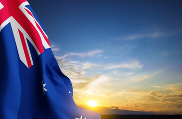 Flag of Australia against the sunset. Australia Day background - obrazy, fototapety, plakaty