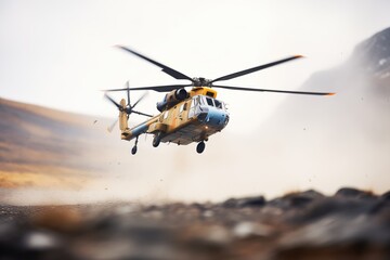 Fototapeta na wymiar helicopter landing on mountain clearing, rotors spinning