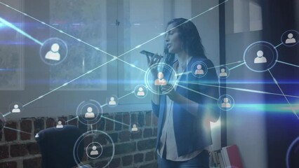 Animation of network of connections over biracial businesswoman talking on smartphone in office - Powered by Adobe