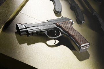Semi-Automatic Handgun on Rustic Wooden Surface Under Harsh Lighting