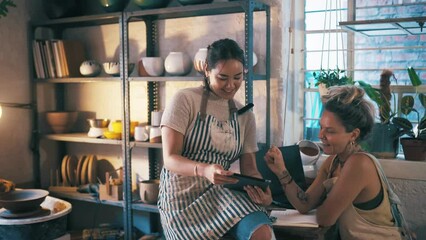 Women, tablet and pottery studio for stocktaking, happy and entrepreneurs in workshop. Small business, creatives and colleagues in handcraft profession, working together and artisan startup store