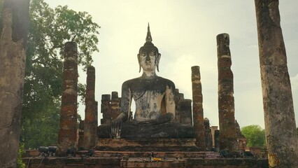 Wat Mahatat temple, Sukhothai historical park, Sukhothai, Thailand. Ancient buddha statue at Wat Mahathat temple in Sukhothai historical park, Thailand. UNESCO World heritage site