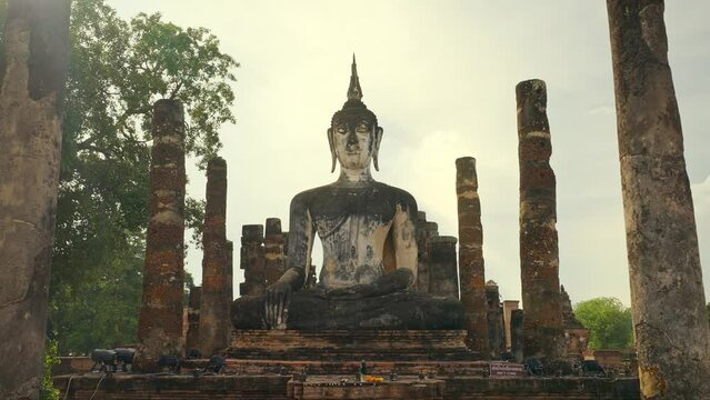 Wat Mahatat temple, Sukhothai historical park, Sukhothai, Thailand. Ancient buddha statue at Wat Mahathat temple in Sukhothai historical park, Thailand. UNESCO World heritage site - Powered by Adobe