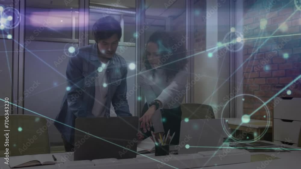 Poster animation of network of connections over diverse colleagues using laptops in office
