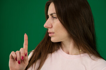 beautiful woman showing expressions. different emotions of a young girl on a green background...