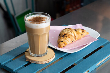 Capuccinno still life with cinnamon and croissant, food concept.