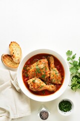 Obraz na płótnie Canvas Chicken stew with tomatoes and herbs