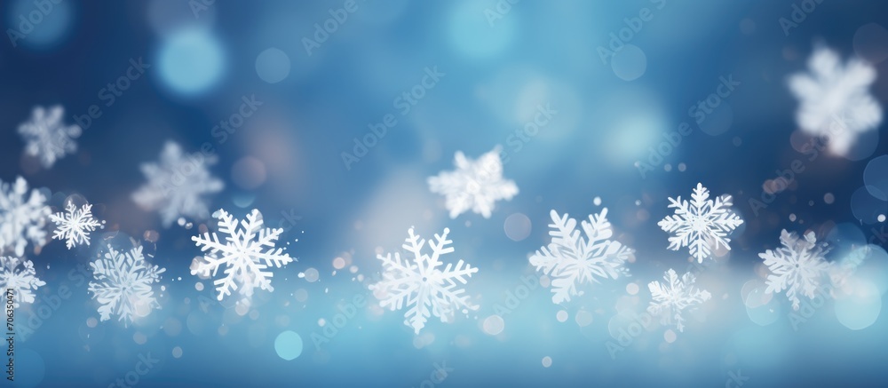Poster blue background with bokeh in the shape of snowflakes.