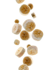 Banana pieces fall in space. Surround light from behind. Isolated on white