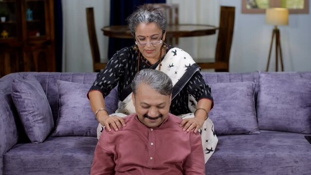A retired old lady / a caring housewife is massaging tired husband's shoulders - massage . Body massage in old age - strong bones  body ache  home therapy  old routine  dadi ma ke nuskhe  caring fa...