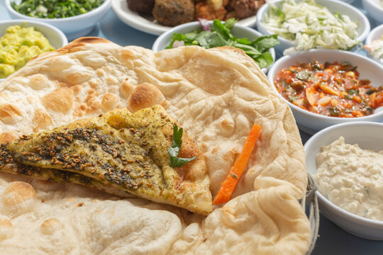 Still life flatbread with zaatar and Israeli meze appetizers
