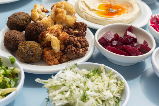 Still life Israeli meze of falafel, hummus, beets and salad
