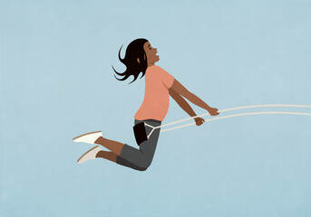 Carefree girl swinging on swing against blue background
