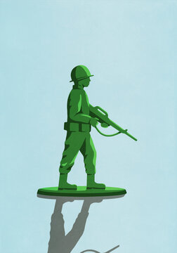 Green soldier with rifle toy on blue background
