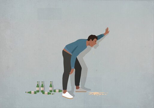 Drunk man vomiting at wall
