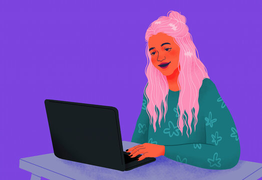 Smiling teenage girl using laptop on purple background

