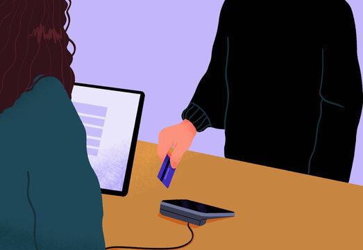 Male customer paying with credit card at retail counter
