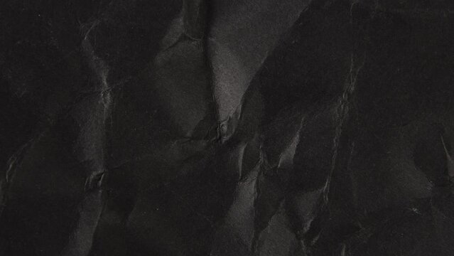 Stop motion animated crumpled black paper texture background.