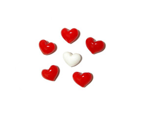 A white heart surrounded by five red hearts on white background.