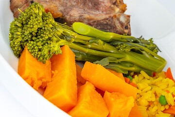 Tender Stem Broccolli Sweet Potatoe and Savoury Rice with a Lamb Chop at the Rear