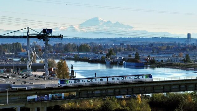 SkyTrain Traveling On Canada Line Rapid Transit System Over The Fraser River To Marine Drive Station In Canada. - aerial shot