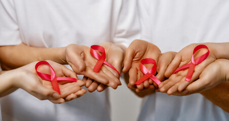 Hands of women with pink ribbon