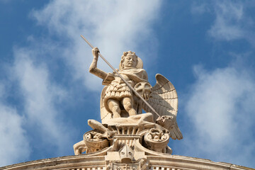 Statue of St Michael killing the Satan , on the top of St Jacobs cathedral in Sibenik, Croatia, low angle view