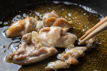 鶏肉(鶏モモ肉)を卵とじするためだし汁で煮る、調理シーン。
